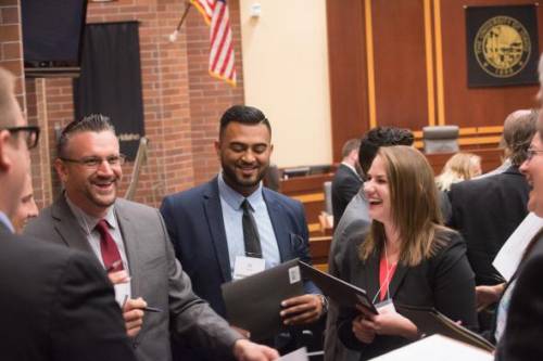 Students from the College of Law at University of Idaho share a few laughs during a meeting in the Moot Courtroom. 