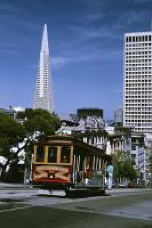 San Francisco cable car on a hill overlooking the Financial District.