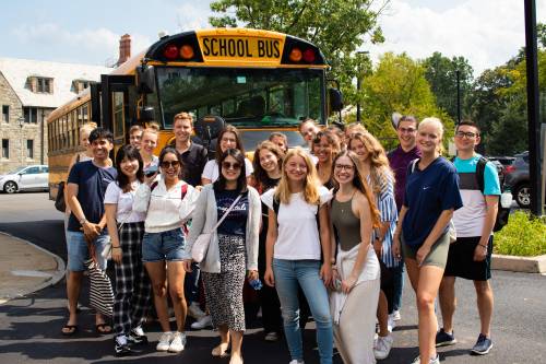 Students take an American school bus during an orientation outing.